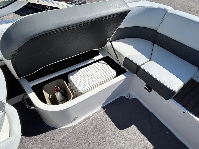 Slide: The Image of 2013 Regal 2300 Bowrider boat interior with open storage compartment and cooler. - 15