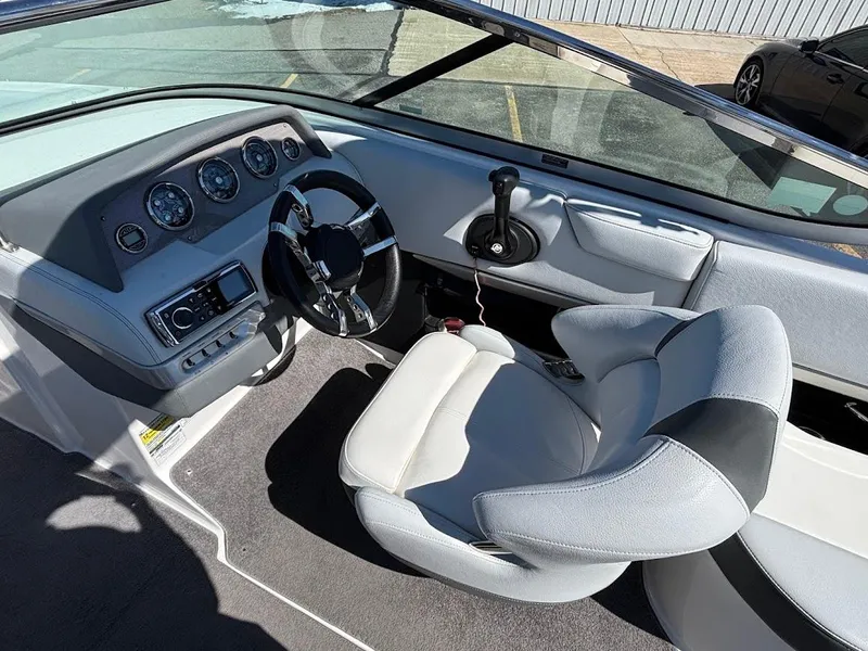 Slide: The Image of 2013 Regal 2300 Bowrider cockpit with steering wheel and dashboard controls. - 17