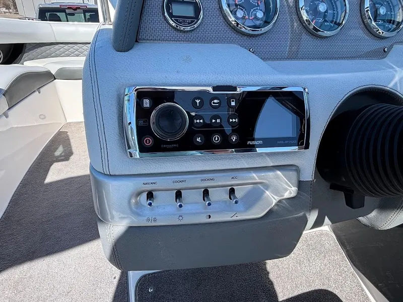 Slide: The Image of Control panel of 2013 Regal 2300 Bowrider boat with stereo system and switches. - 18