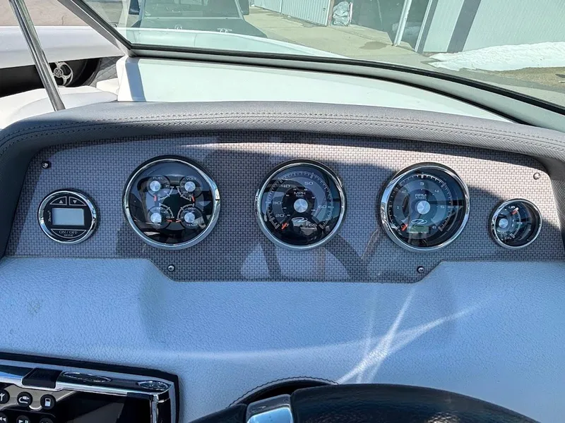 Slide: The Image of Dashboard of a 2013 Regal 2300 Bowrider boat with multiple gauges and controls. - 20