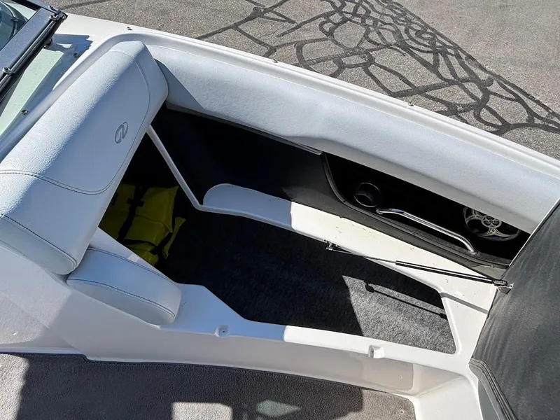 Slide: The Image of 2013 Regal 2300 Bowrider interior with white seating and storage compartment. - 22