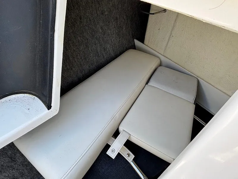 Slide: The Image of Interior seating of 2013 Regal 2300 Bowrider boat, featuring white cushioned seats. - 23