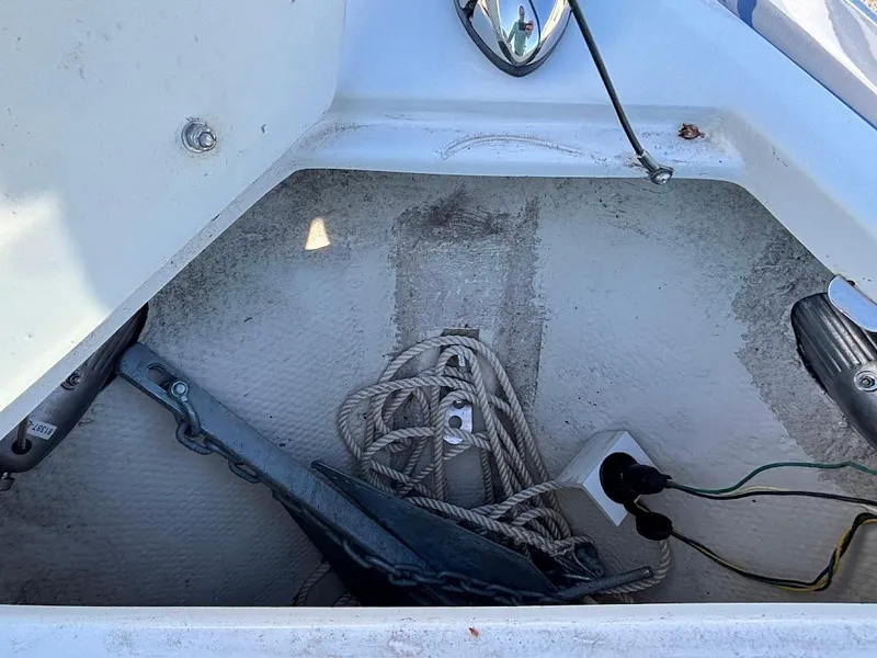 Slide: The Image of Anchor storage area of 2013 Regal 2300 Bowrider boat with ropes and wiring. - 24