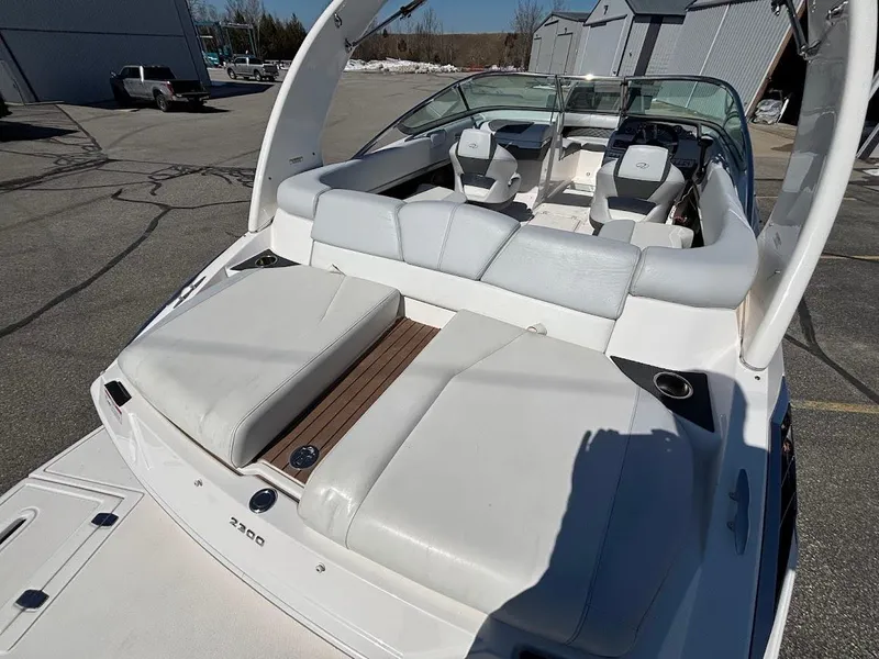 Slide: The Image of 2013 Regal 2300 Bowrider boat with spacious seating and sleek design. - 9