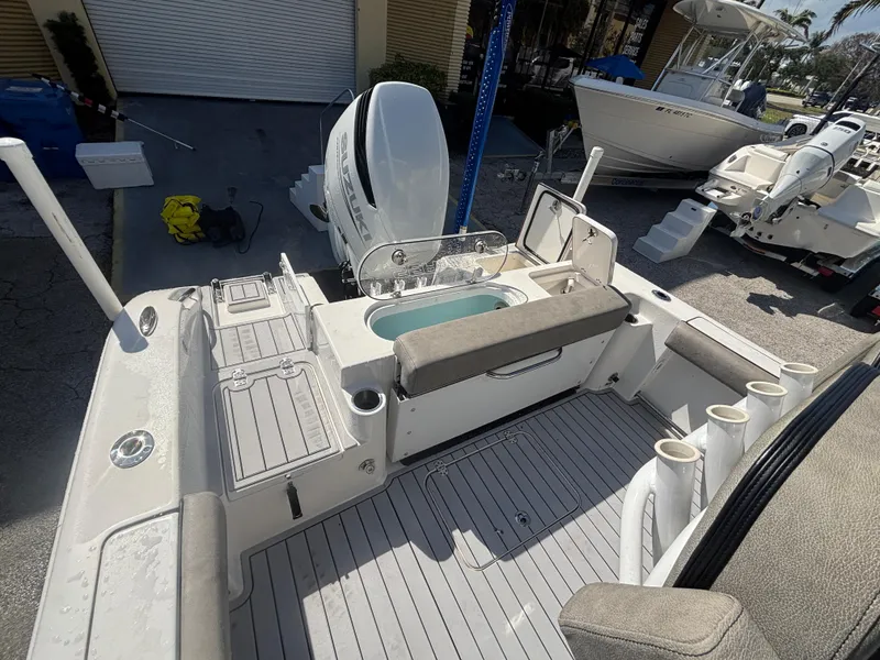 Slide: The Image of 2022 Sea Pro 239 Center Console boat interior with seating and storage compartments. - 19