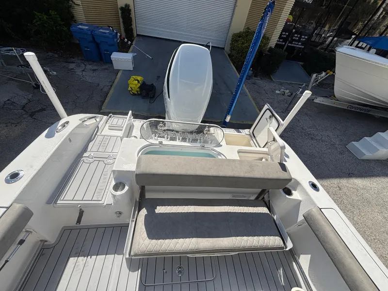 Slide: The Image of 2022 Sea Pro 239 Center Console boat interior with seating and storage compartments. - 20