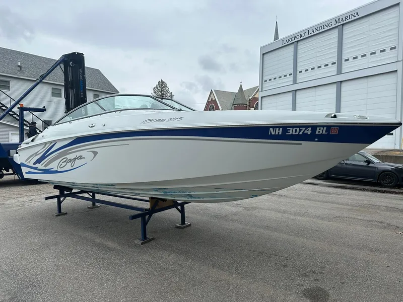 Slide: The Image of 2005 Baja 245 Performance boat on stand at a marina, side view. - 1