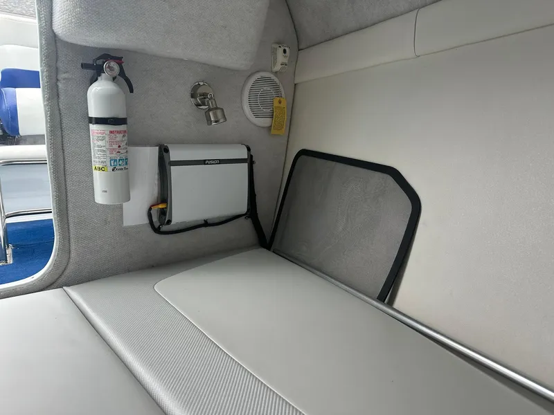 Slide: The Image of Interior of a 2005 Baja 245 Performance boat with fire extinguisher and speaker. - 10