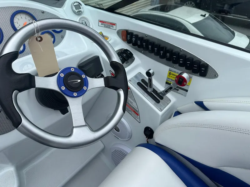 Slide: The Image of 2005 Baja 245 Performance boat cockpit with steering wheel and control panel. - 18