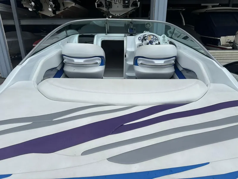 Slide: The Image of 2005 Baja 245 Performance boat interior with stylish seating and modern dashboard. - 4