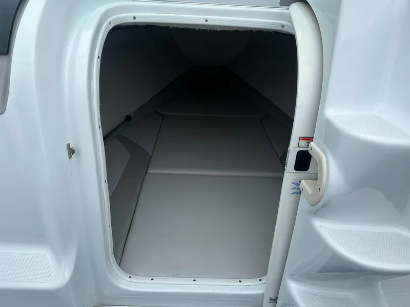 Slide: The Image of 2005 Baja 245 Performance boat cabin interior with white upholstery. - 7