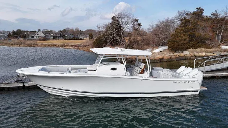 The Image of 2025 Southport 38 FE boat docked by a scenic shoreline. - 0