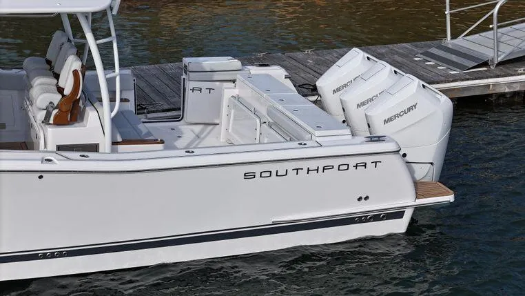 Slide: The Image of 2025 Southport 38 FE boat with triple Mercury engines docked on water. - 10
