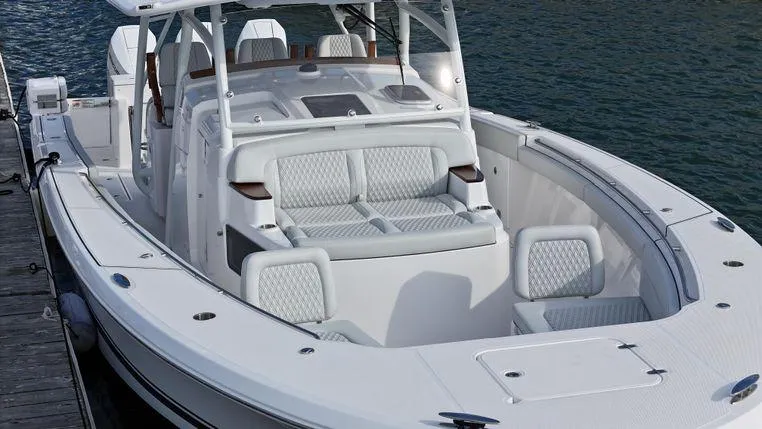 Slide: The Image of 2025 Southport 38 FE boat with luxurious seating, docked by the water. - 11