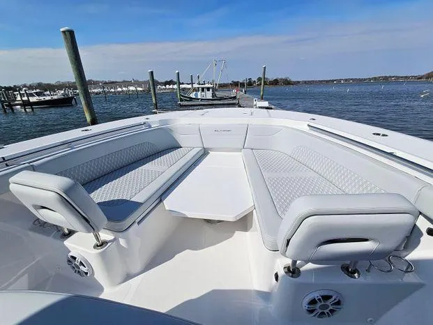 Slide: The Image of 2025 Southport 38 FE boat with spacious seating, docked by the water. - 20