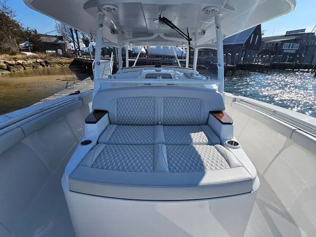 Slide: The Image of 2025 Southport 38 FE boat interior with luxurious seating and waterfront view. - 23