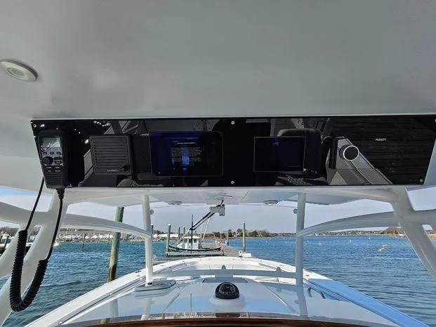 Slide: The Image of 2025 Southport 38 FE boat dashboard with navigation equipment, overlooking a serene marina view. - 28