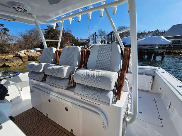 Slide: The Image of Luxury seating on 2025 Southport 38 FE boat, docked by the water. - 29