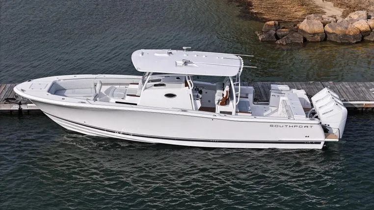 Slide: The Image of 2025 Southport 38 FE boat docked on calm water, side view. - 3
