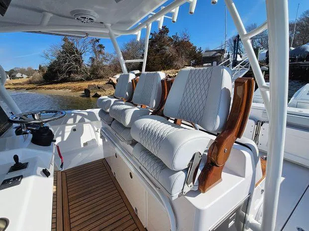 Slide: The Image of 2025 Southport 38 FE boat interior with luxurious seating and wooden accents. - 30