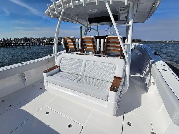 Slide: The Image of 2025 Southport 38 FE boat with spacious seating and sleek design on a sunny day. - 39
