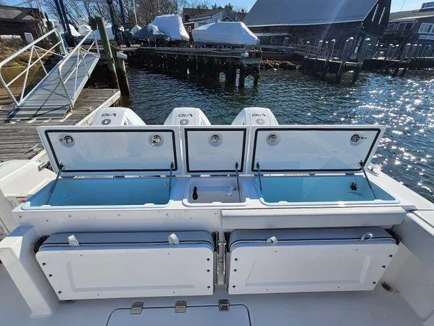 Slide: The Image of 2025 Southport 38 FE boat with open storage compartments by the dock. - 45