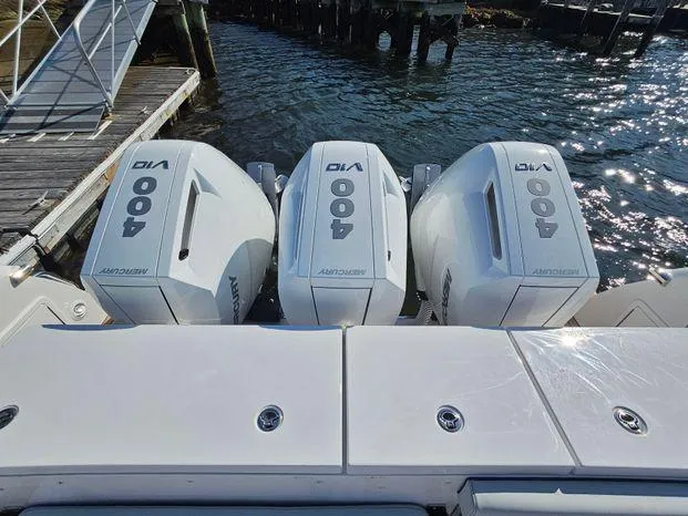 Slide: The Image of Triple 400 horsepower engines on a 2025 Southport 38 FE boat at a dock. - 47