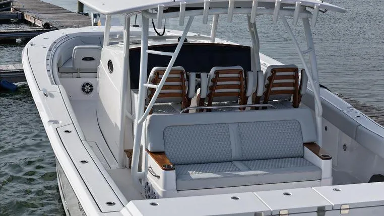 Slide: The Image of 2025 Southport 38 FE boat with spacious seating and sleek design at the dock. - 8