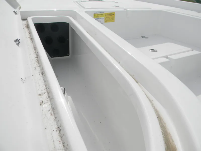 Slide: The Image of 2023 NauticStar 227 XTS boat storage compartment, white interior, open hatch. - 10