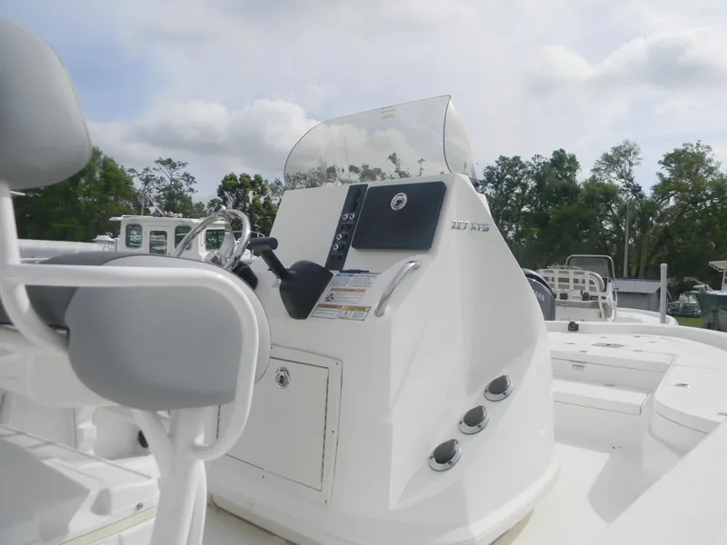 Slide: The Image of 2023 NauticStar 227 XTS boat console with steering wheel and controls. - 4