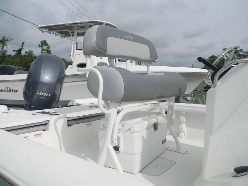 Slide: The Image of 2023 NauticStar 227 XTS boat with seating and outboard motor. - 5