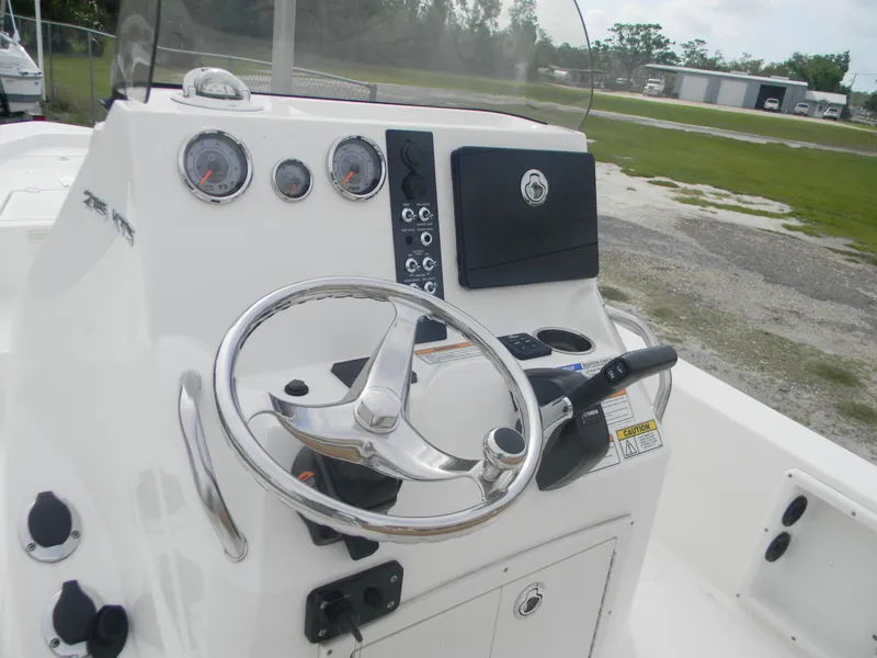 Slide: The Image of 2023 NauticStar 227 XTS boat console with steering wheel and gauges. - 8