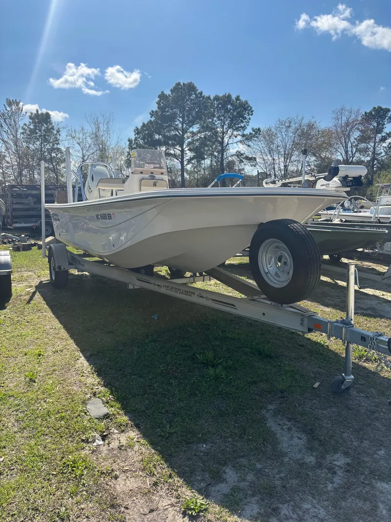 Slide: The Image of 2021 Carolina Skiff 21 LS boat on trailer, parked outdoors under a clear sky. - 7
