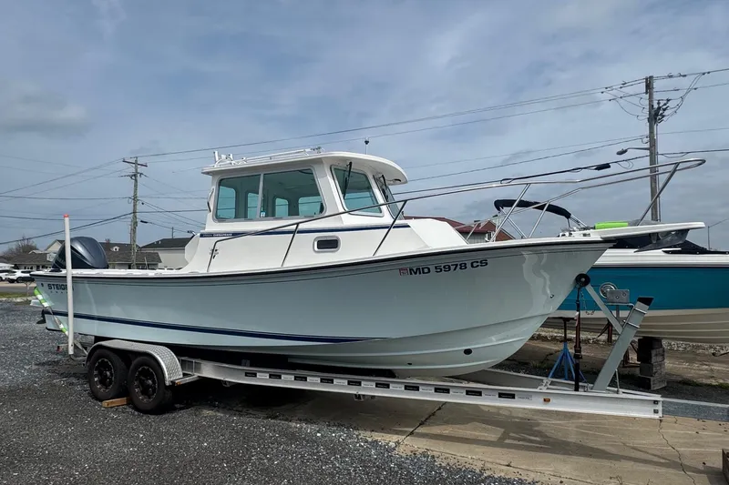 Slide: The Image of 2017 Steiger Craft 255 DV Chesapeake boat on trailer, parked outdoors. - 0