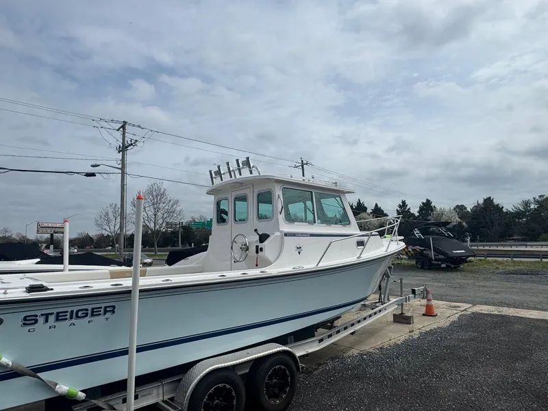 Slide: The Image of 2017 Steiger Craft 255 DV Chesapeake boat on trailer under cloudy sky. - 10