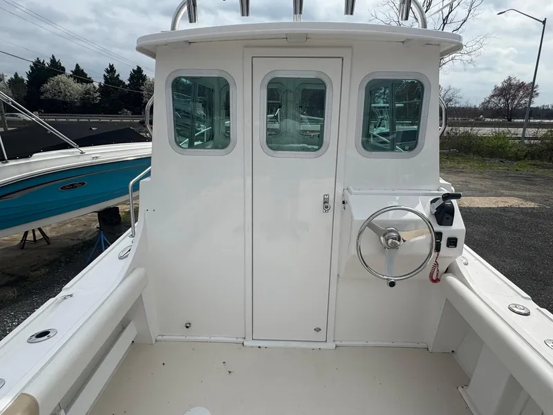 Slide: The Image of 2017 Steiger Craft 255 DV Chesapeake boat, white exterior, rear view with steering wheel. - 12