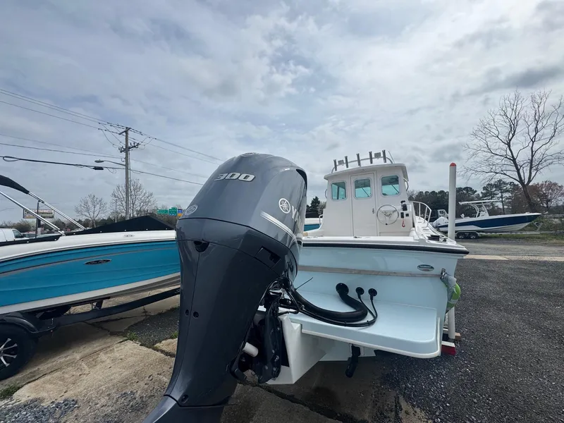 Slide: The Image of 2017 Steiger Craft 255 DV Chesapeake boat with outboard motor, parked outdoors. - 15