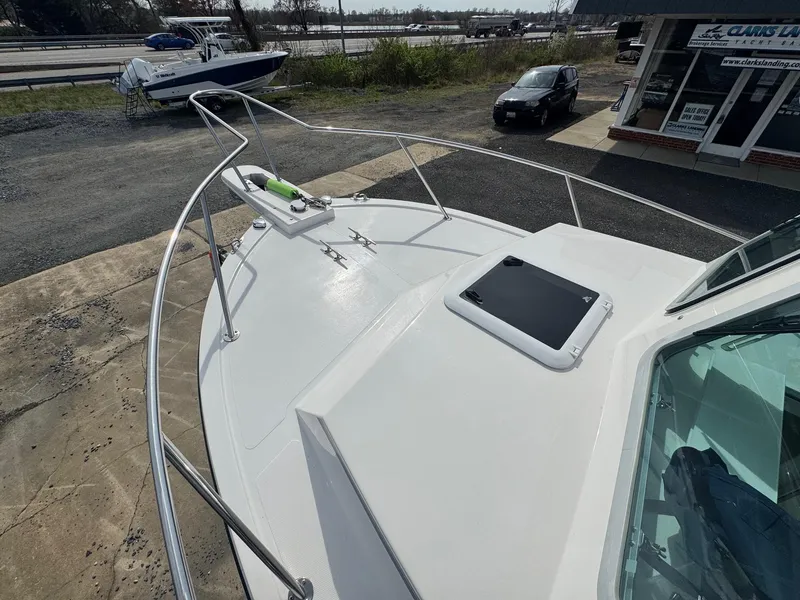 Slide: The Image of 2017 Steiger Craft 255 DV Chesapeake boat deck with railing and hatch, docked outdoors. - 19