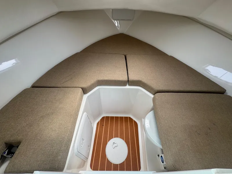 Slide: The Image of 2017 Steiger Craft 255 DV Chesapeake cabin interior with cushioned seating and wood flooring. - 2