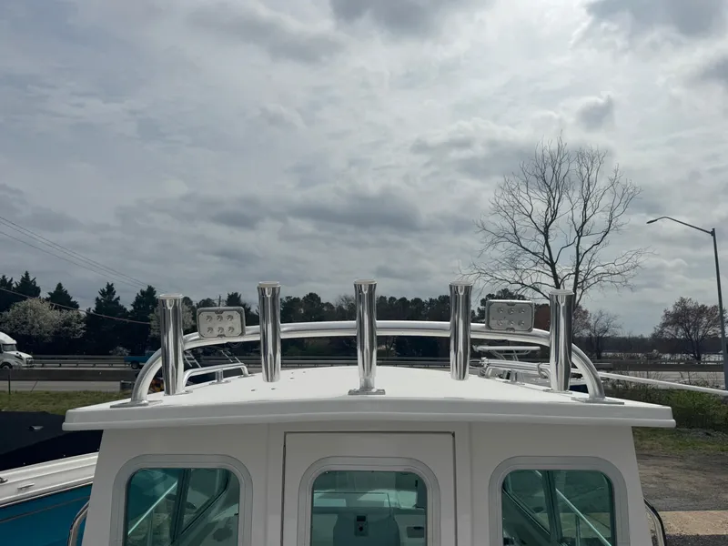 Slide: The Image of 2017 Steiger Craft 255 DV Chesapeake boat with rod holders and overcast sky. - 22