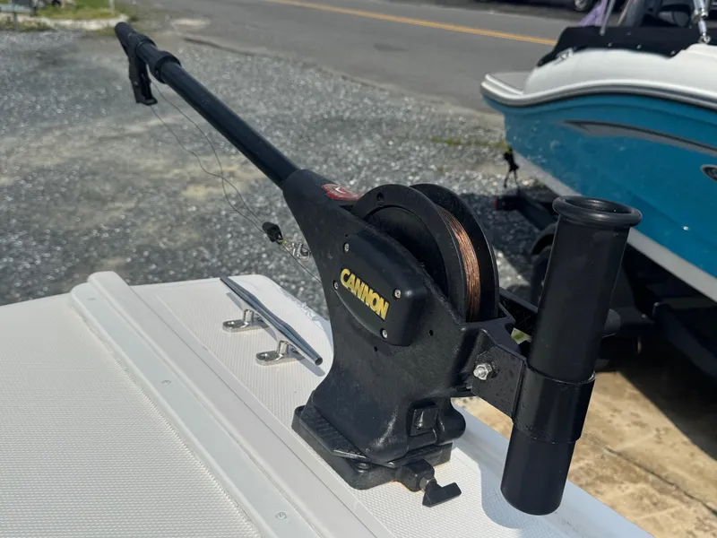 Slide: The Image of Cannon downrigger on 2017 Steiger Craft 255 DV Chesapeake boat, parked on gravel. - 29