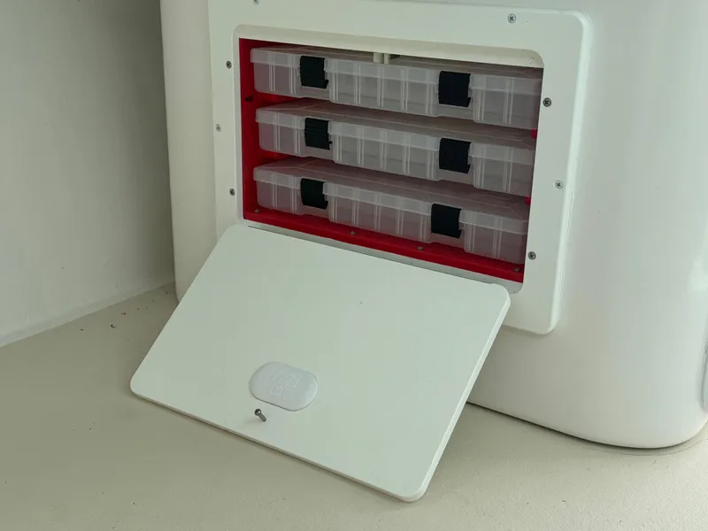 Slide: The Image of 2017 Steiger Craft 255 DV Chesapeake tackle storage compartment with open door and organized boxes. - 31