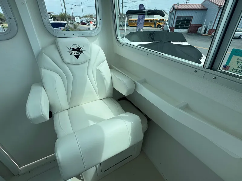 Slide: The Image of White captain's chair inside 2017 Steiger Craft 255 DV Chesapeake boat cabin. - 33