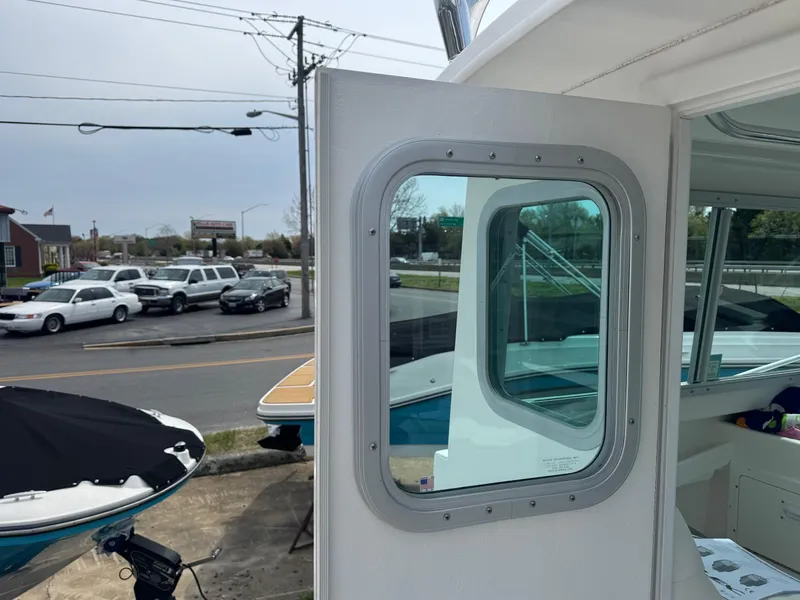 Slide: The Image of 2017 Steiger Craft 255 DV Chesapeake boat with open cabin door, parked near road. - 38