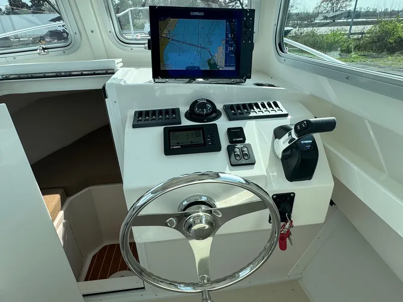 Slide: The Image of Steiger Craft 255 DV Chesapeake 2017 helm with navigation equipment and steering wheel. - 4