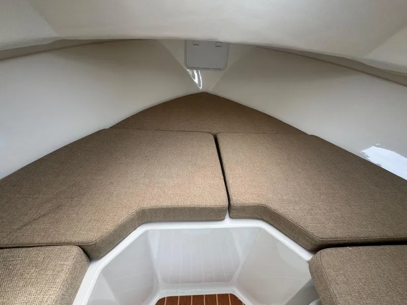 Slide: The Image of 2017 Steiger Craft 255 DV Chesapeake cabin interior with cushioned seating and white walls. - 43