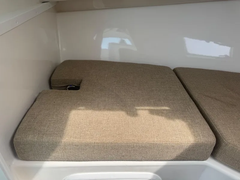 Slide: The Image of 2017 Steiger Craft 255 DV Chesapeake cabin interior with beige cushions. - 44