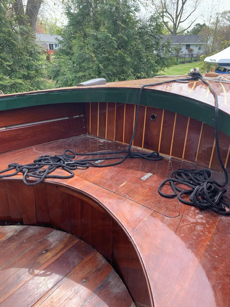 Slide: The Image of Classic 1990 English Launch boat with wooden deck and ropes, surrounded by greenery. - 29