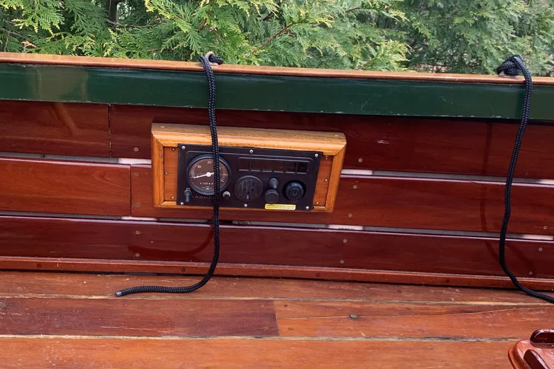 Slide: The Image of Wooden dashboard of a 1990 Classic English Launch boat with control panel. - 31
