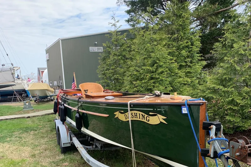 Slide: The Image of Classic 1990 English Launch boat on trailer, surrounded by trees and buildings. - 39